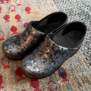 Black, purple and bluish patent Dansko Professional clogs